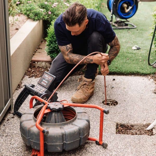 Rusty using a CCTV drain camera to inspect a blocked drain