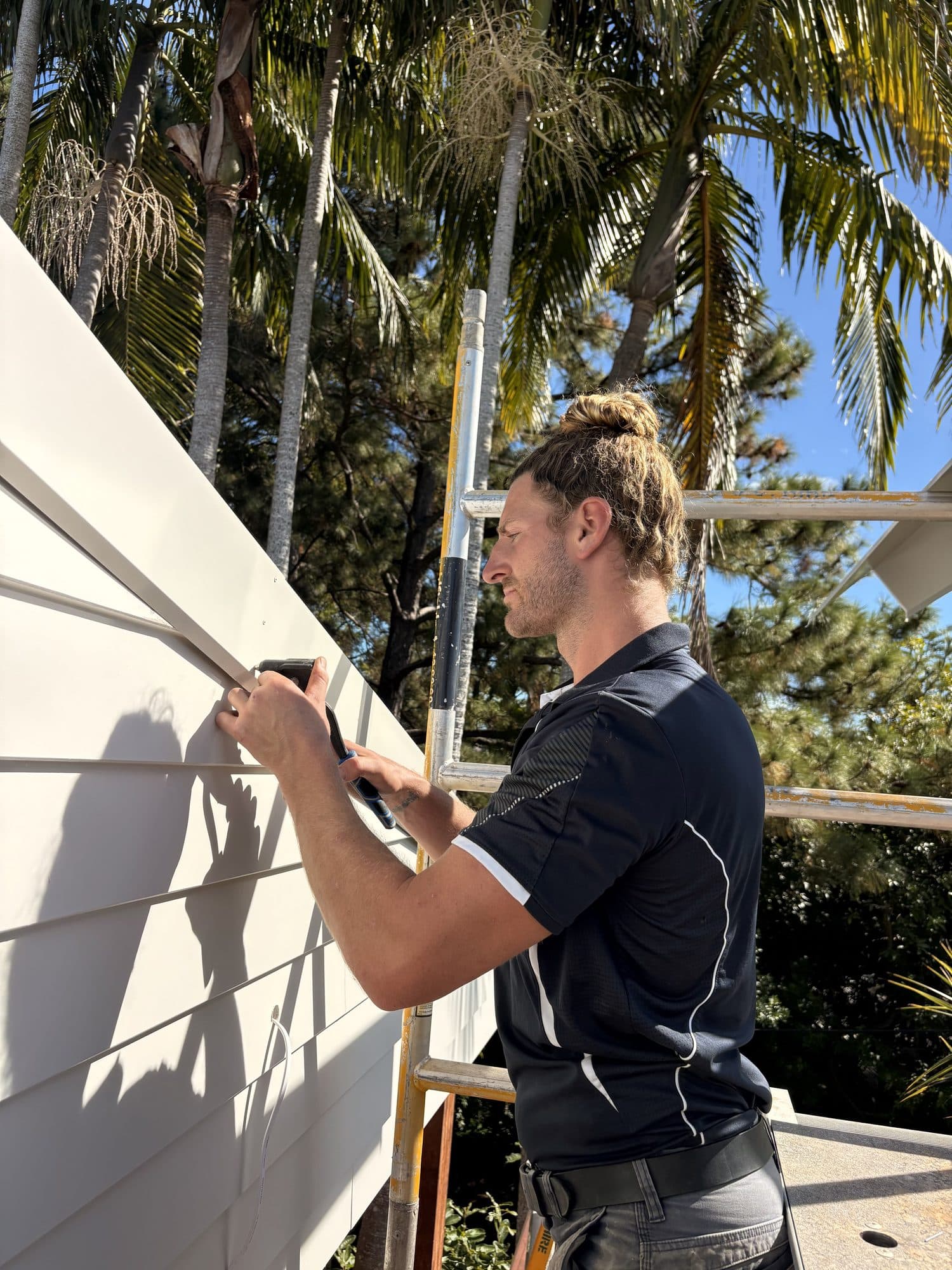 Rusty on scaffolding working on a coastal Queensland weatherboard exterior