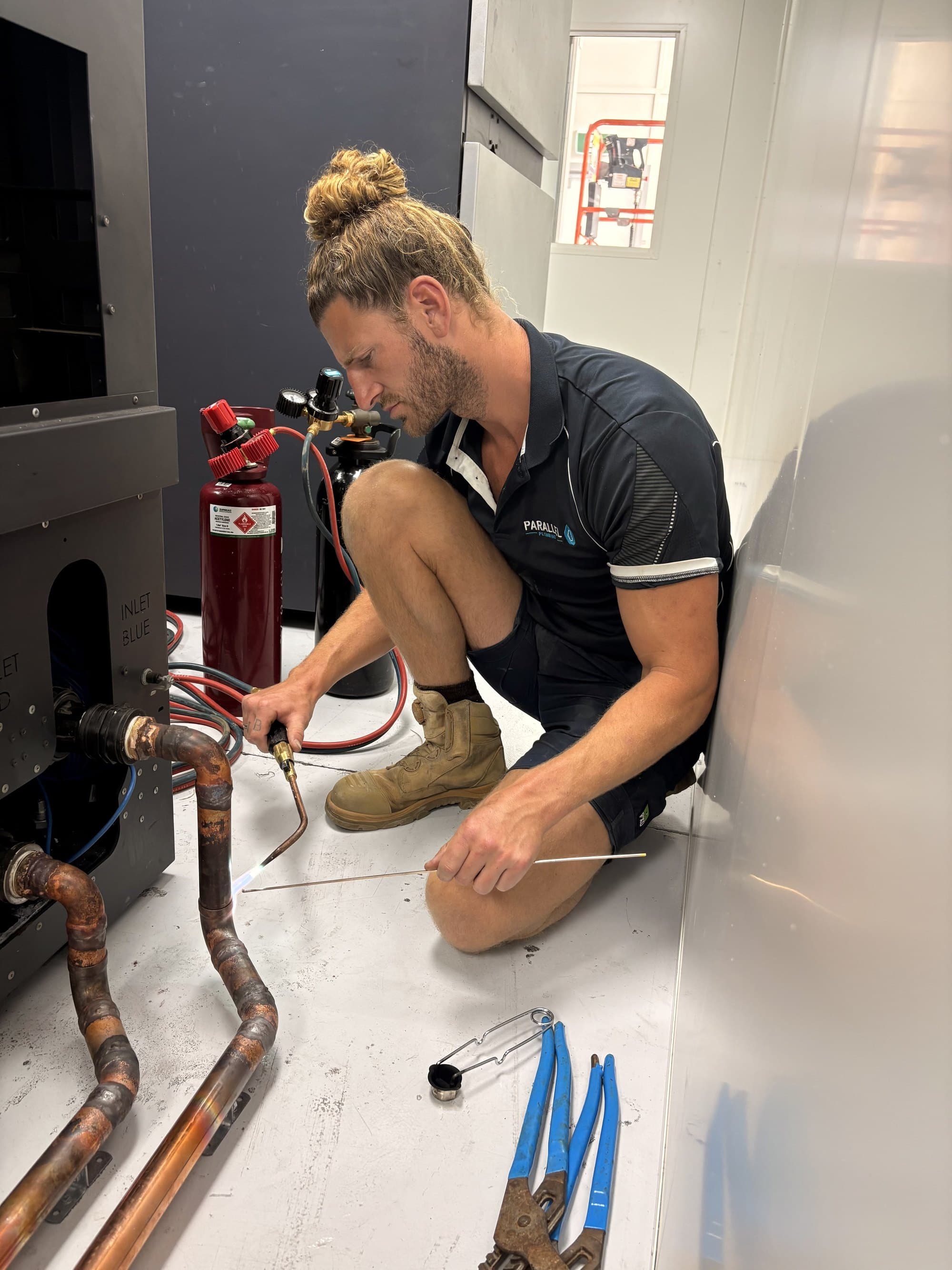 Rusty from Parallel Plumbing brazing copper pipework with an oxy-acetylene torch on a commercial job