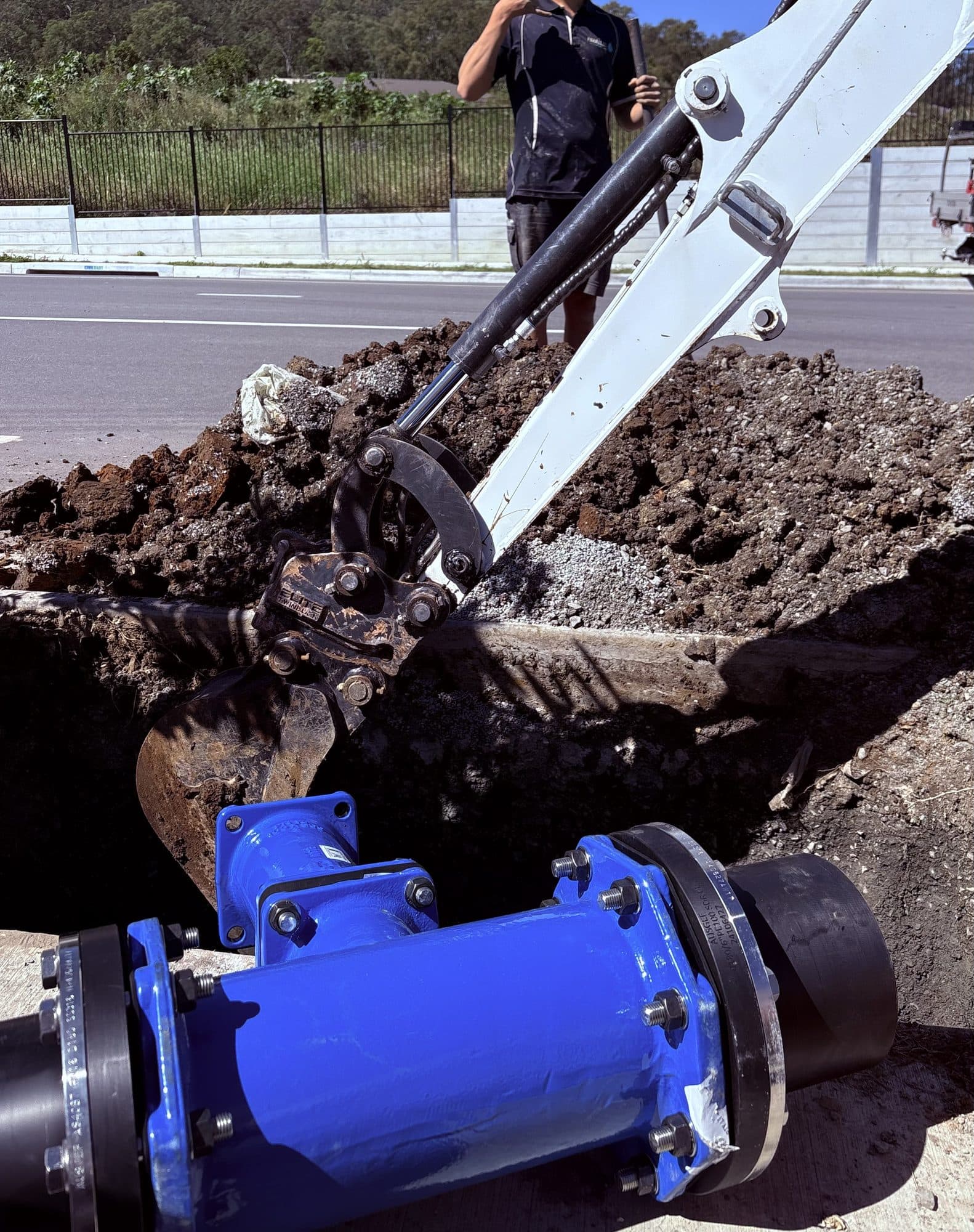 Rusty installing a commercial water main valve with an excavator